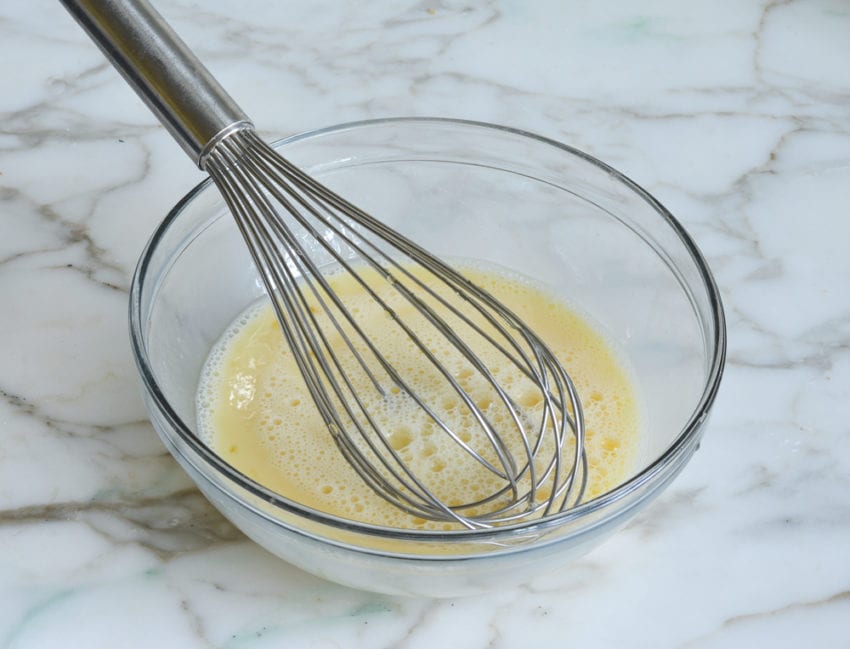 adding honey and milk to the eggs