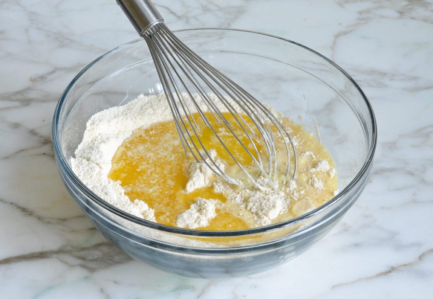 adding liquid ingredients and melted butter to dry ingredients