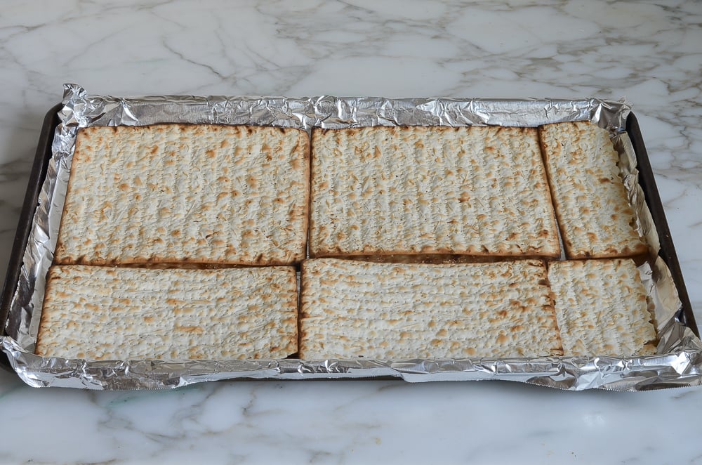 matzo arranged on baking sheet