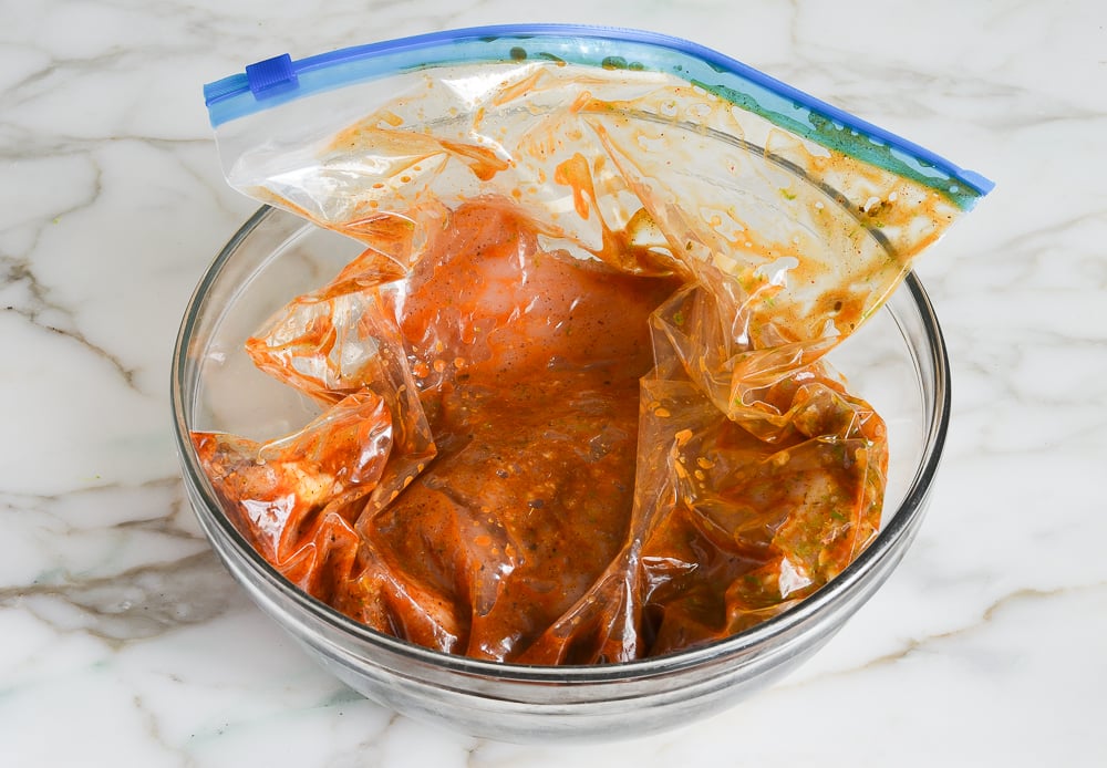 chicken marinating in bowl