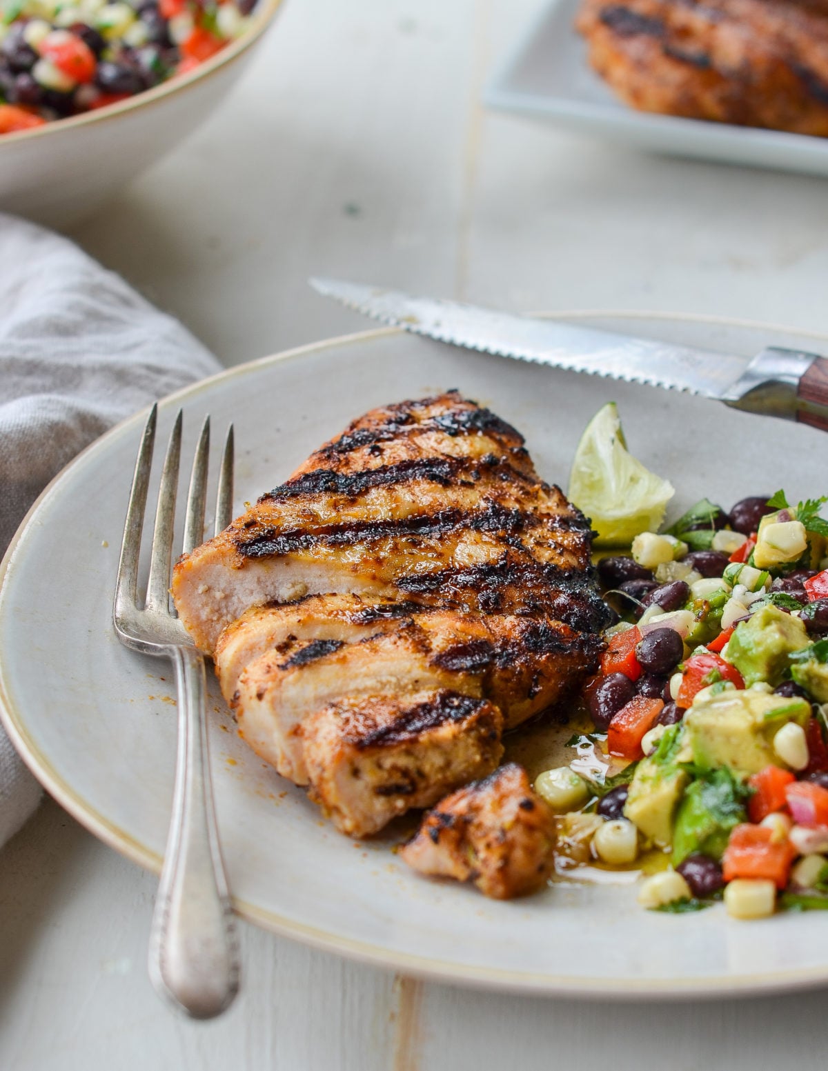 Grilled tequila lime chicken on a plate with salad.
