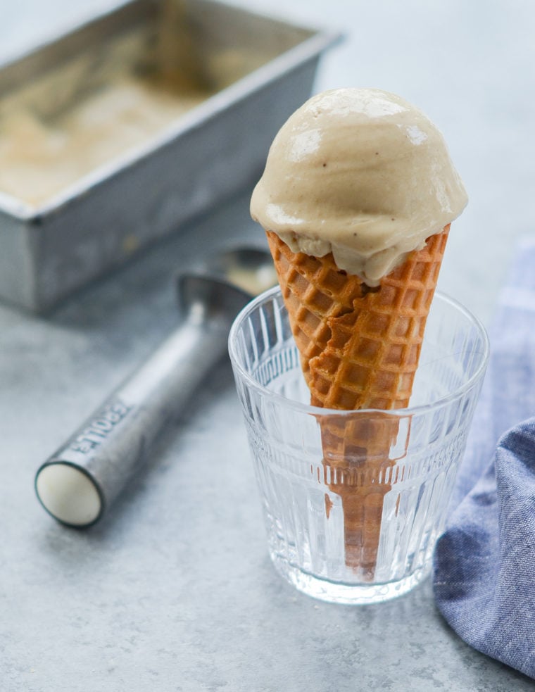 Caramelized banana ice cream cone in a glass.
