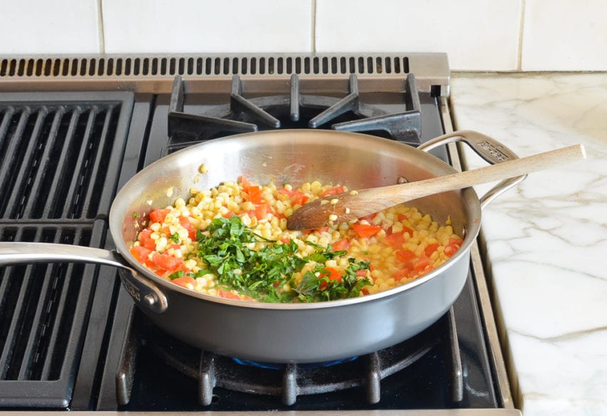 basil added to corn and tomato mixture
