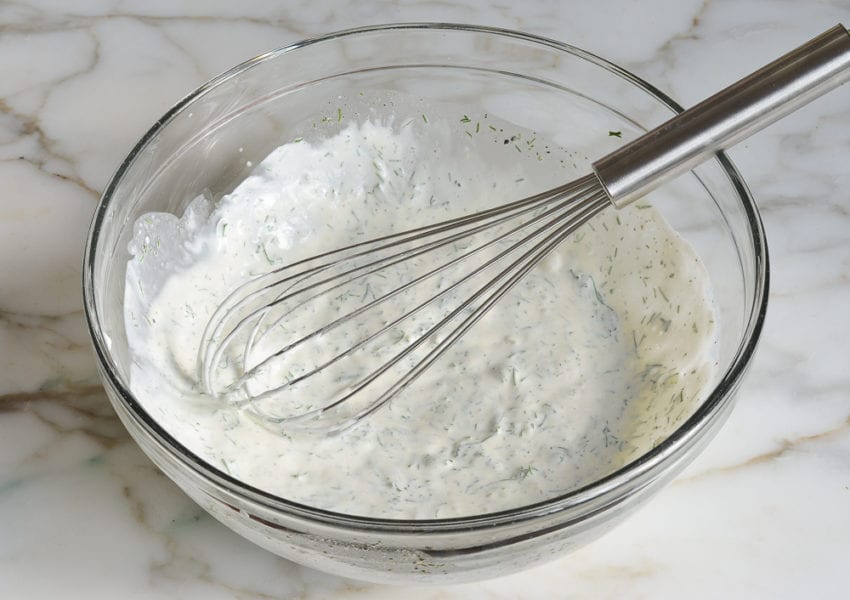Whisk in a bowl of white dressing.