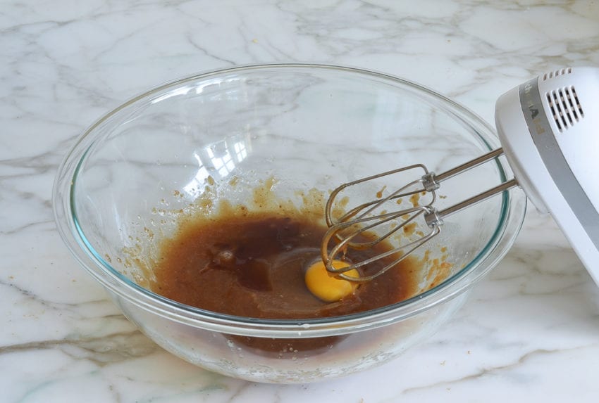 adding egg to butter and sugar mixture