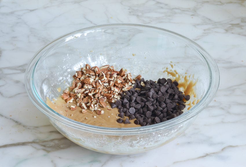 chocolate chips and pecans added to mixing bowl