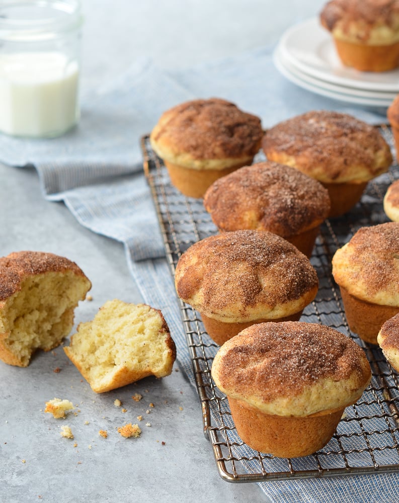 Doughnut muffins on and next to a wire rack.