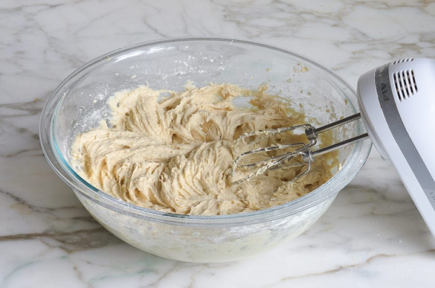 Bowl of muffin batter with an electric mixer.