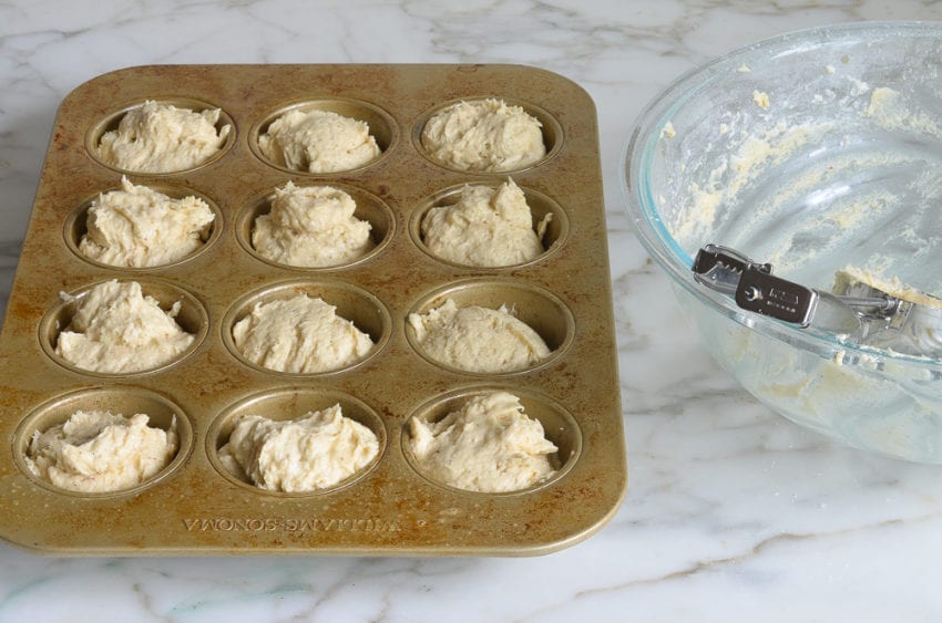 Muffin tin of doughnut muffin batter.