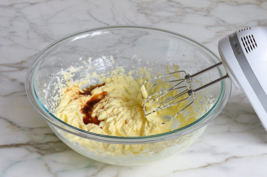 Vanilla added to a bowl of creamed butter and sugar.