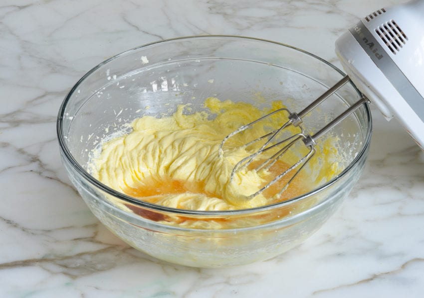 Vanilla and rum in a bowl of creamed butter, sugar, and eggs.