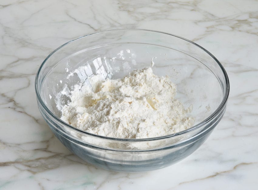 butter mixed with flour in mixing bowl for making chocolate chip scones