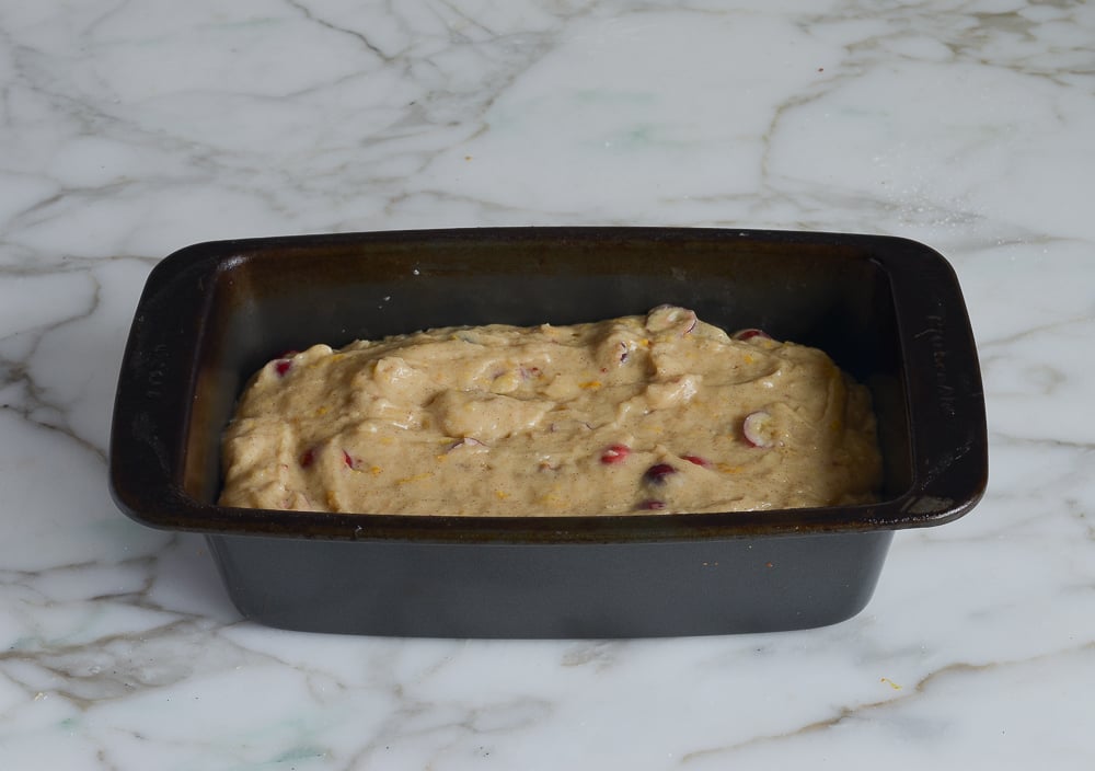 Loaf pan of cranberry nut bread dough.