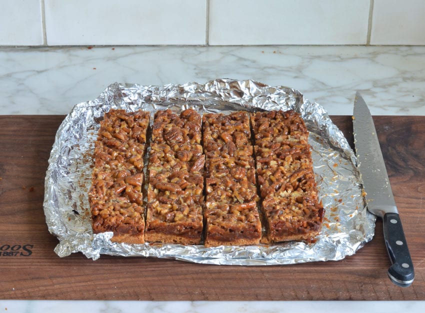 Cut pecan squares on foil.