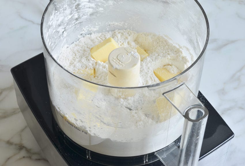 Butter in a food processor with dry ingredients.