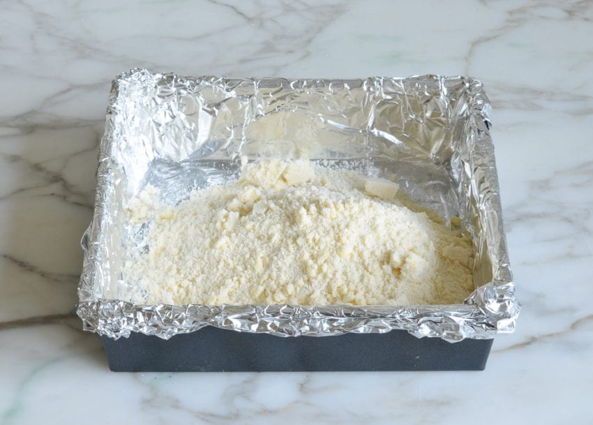 Flour and butter mixture in a foil-lined baking pan.