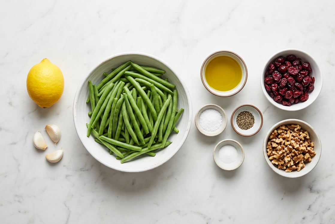 Ingredients including green beans, cranberries, walnuts, lemon, olive oil, and garlic.