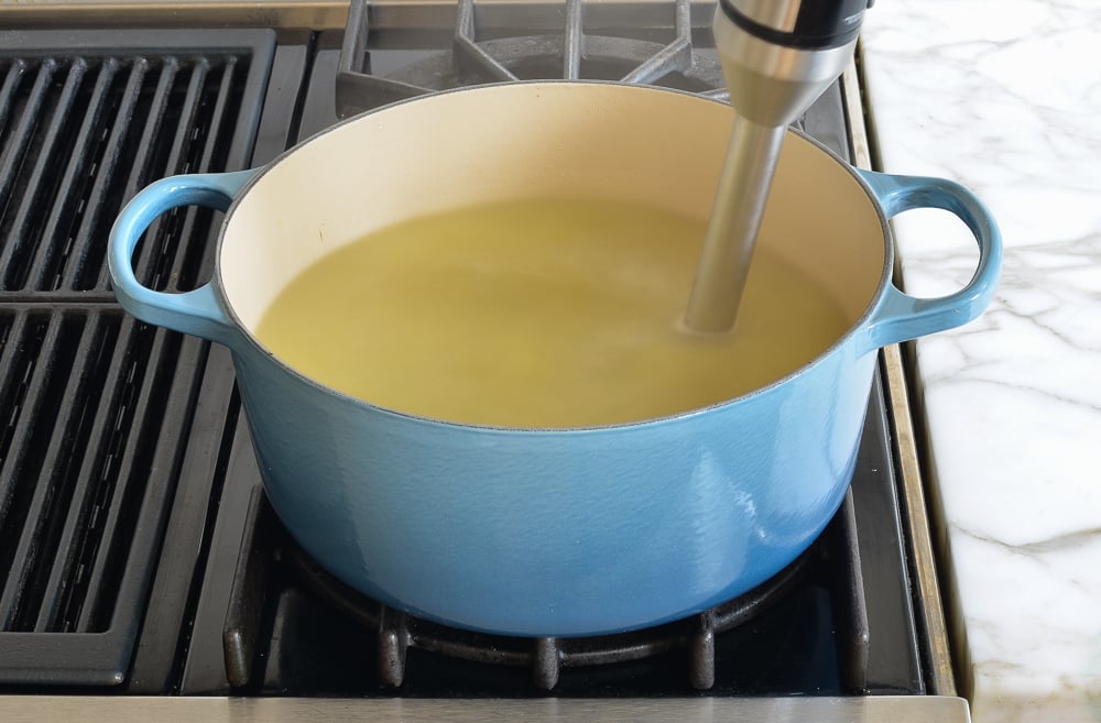 Immersion blender in a pot of soup.