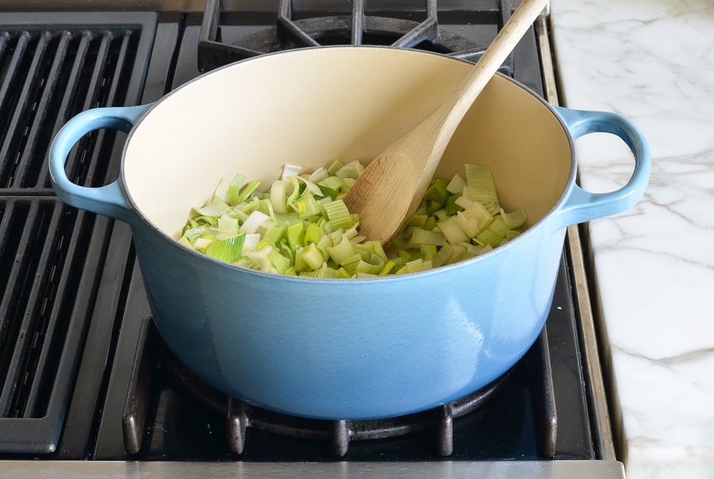 Sliced leeks in a Dutch oven.