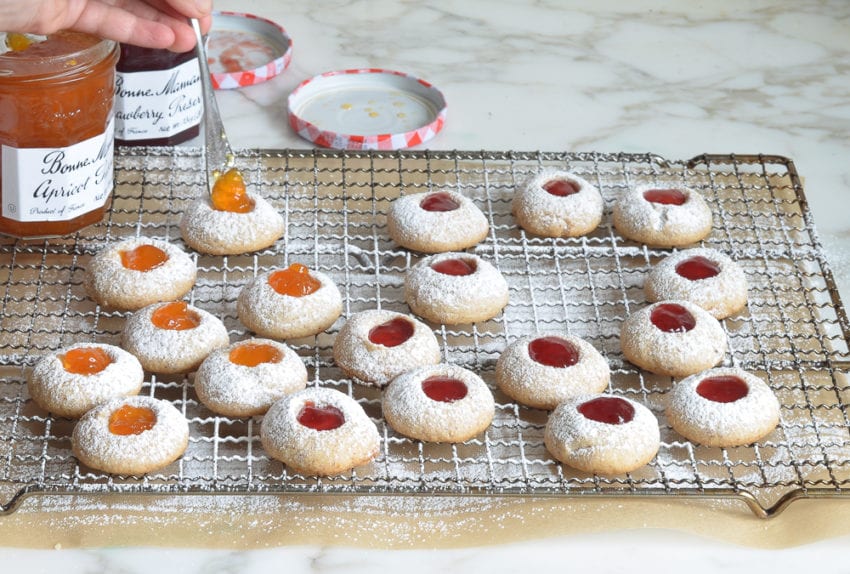 Jam thumbprint cookies on a wire rack.