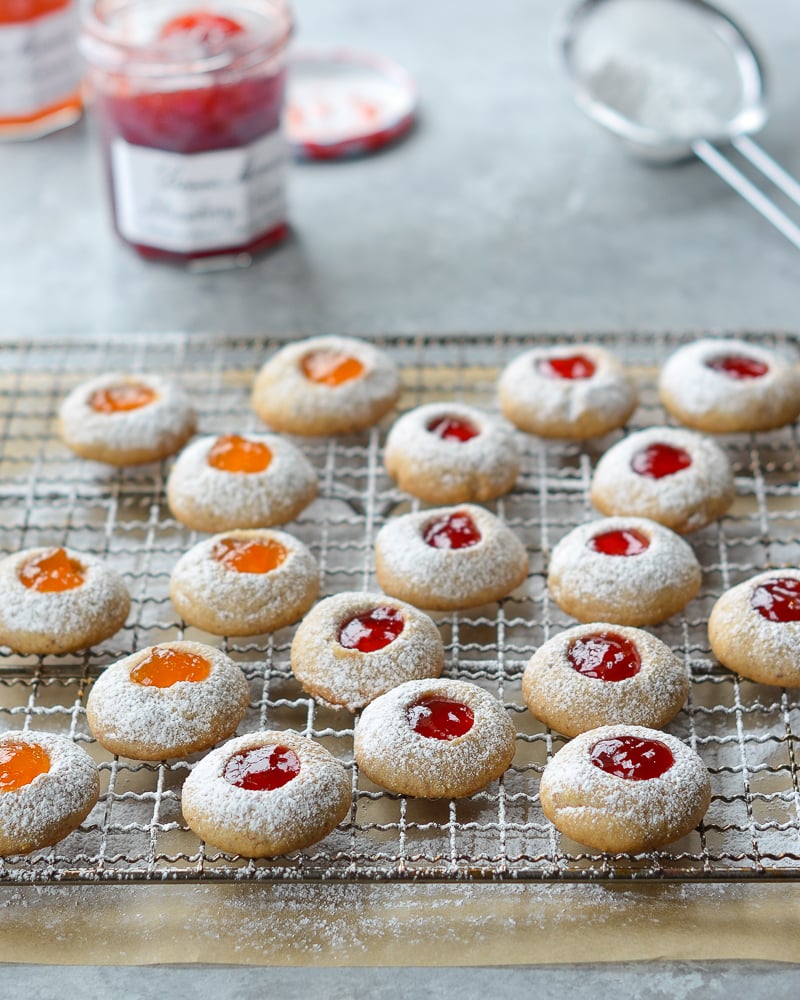 Jam thumbprint cookies on a wire rack.