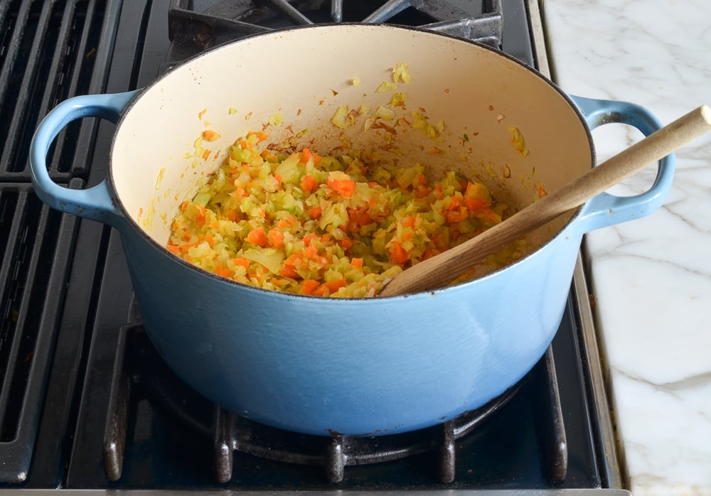 Softened vegetables in a Dutch oven.