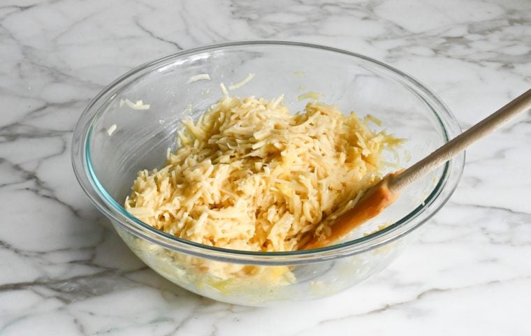 Spatula in a bowl of latke batter.