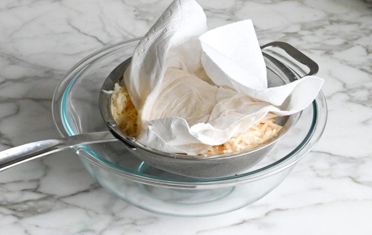 draining liquid from potato and onion mixture
