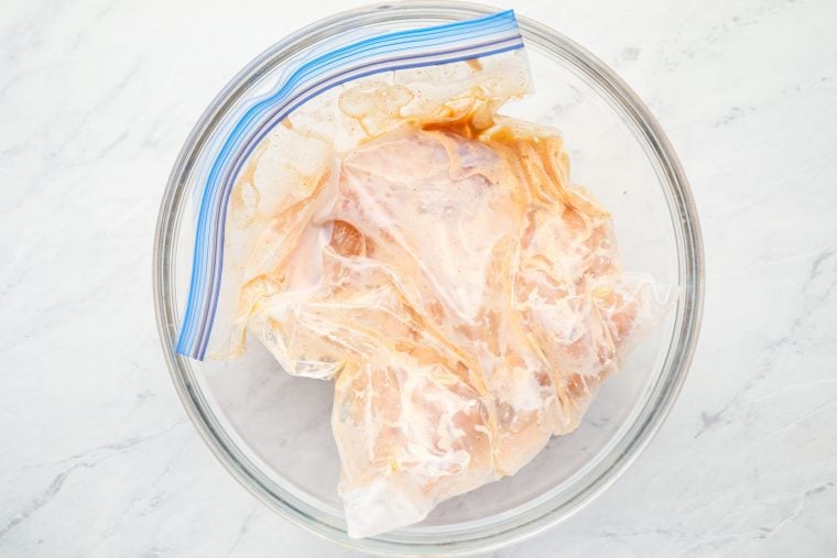 chicken tenders in a bag in a bowl to prevent leakage