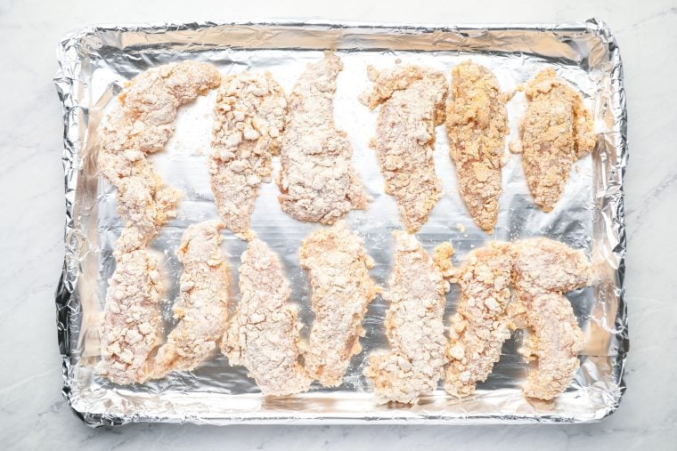 breaded tenders on baking sheet