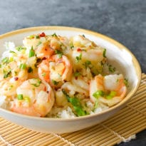 Bowl of Vietnamese-style caramel shrimp over rice.