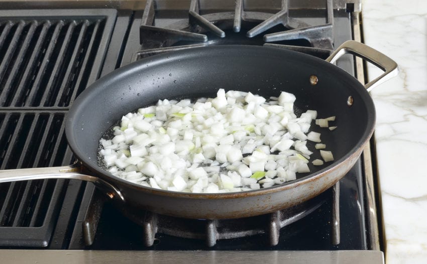 Onions cooking in a skillet.