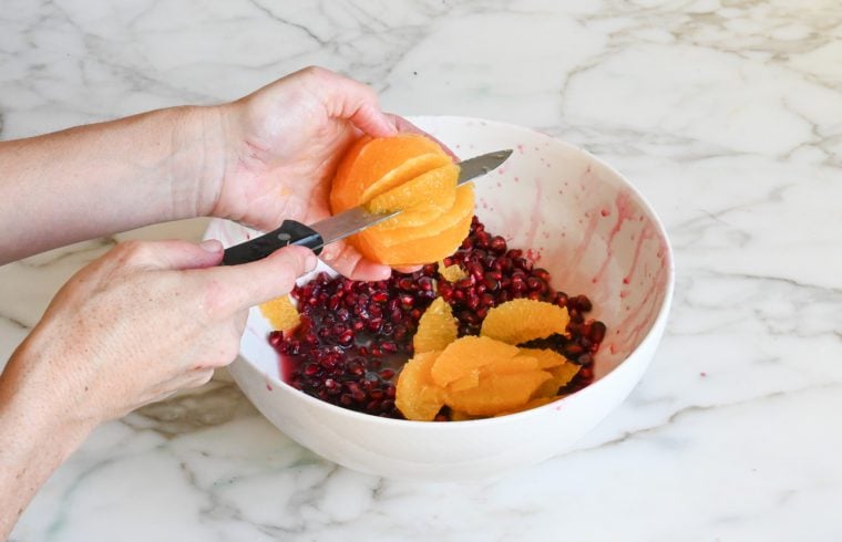 cutting the segments out of the orange