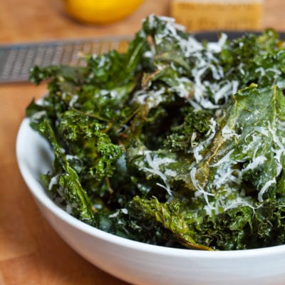 Bowl of kale chips with lemon and parmesan.