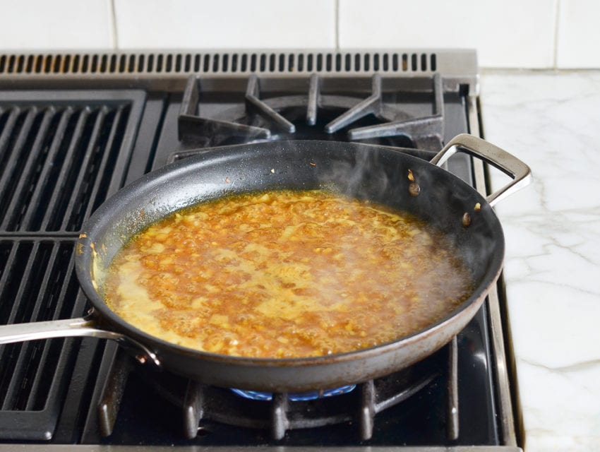 Skillet with onions and chicken stock.