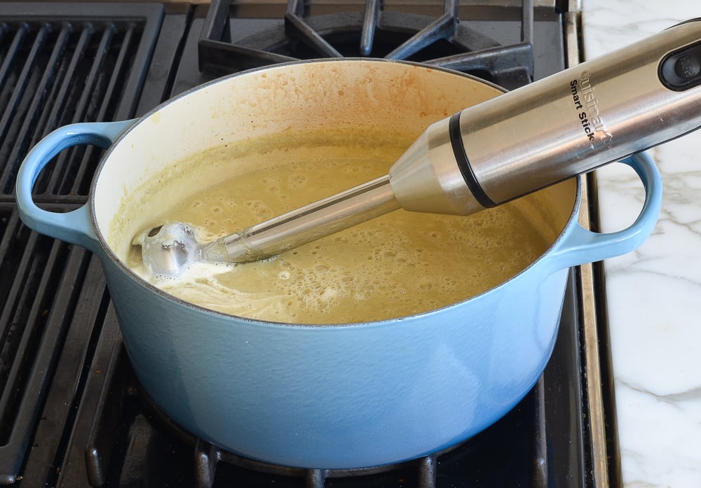 Immersion blender in a pot of soup.