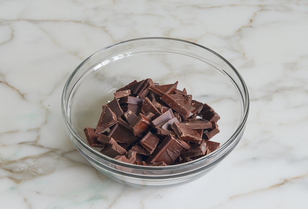 broken chocolate pieces in bowl ready to melt