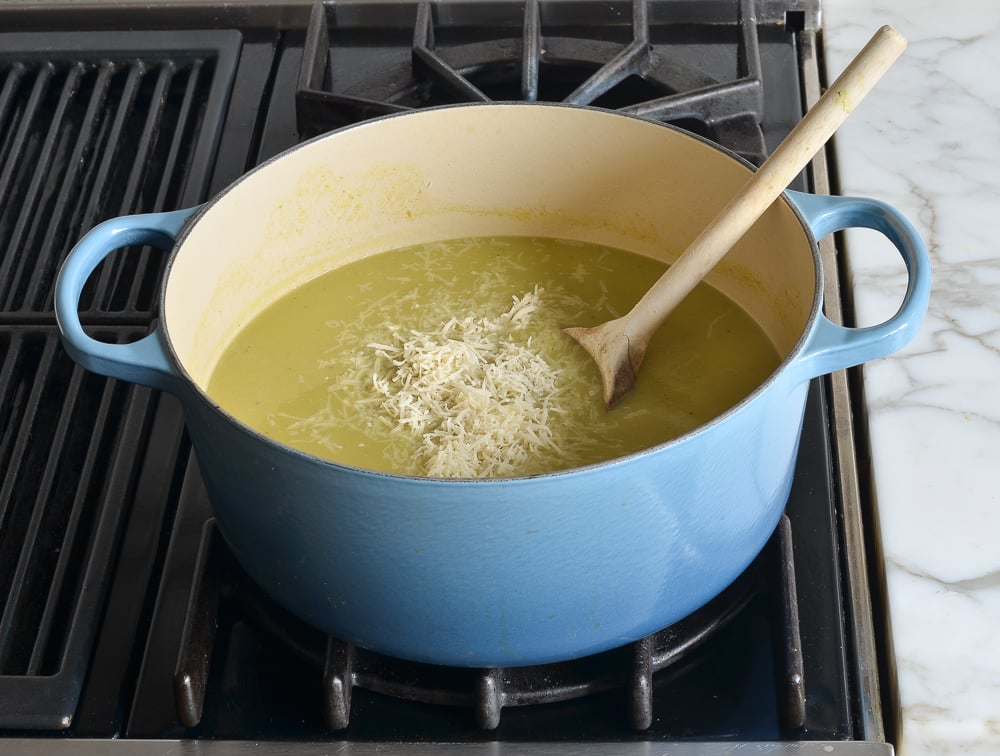Grated parmesan in a Dutch oven of soup.