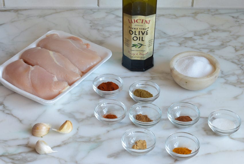Chicken ingredients including spices, olive oil, and garlic.