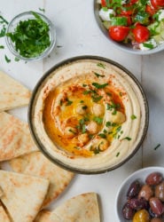 Bowl of hummus topped with whole chickpeas.
