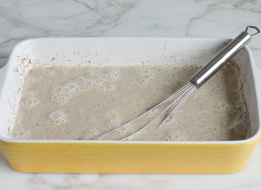 whisked custard ingredients in baking dish