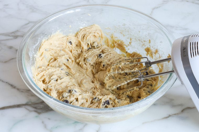 Chocolate chips in a bowl of batter.