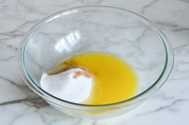 Butter, sugar, and extracts in a bowl.