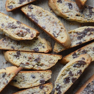 Slices of chocolate chip Mandel bread on parchment paper.