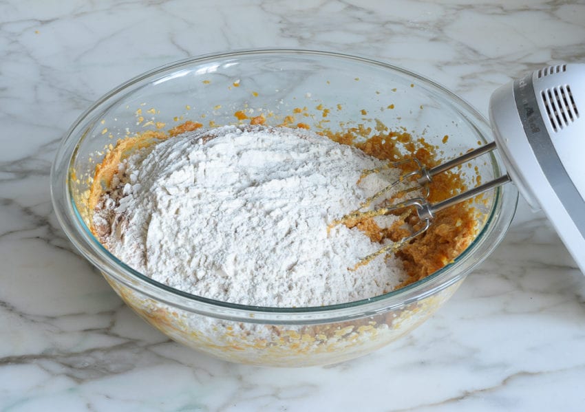 Dry ingredients in a bowl with a pumpkin mixture.