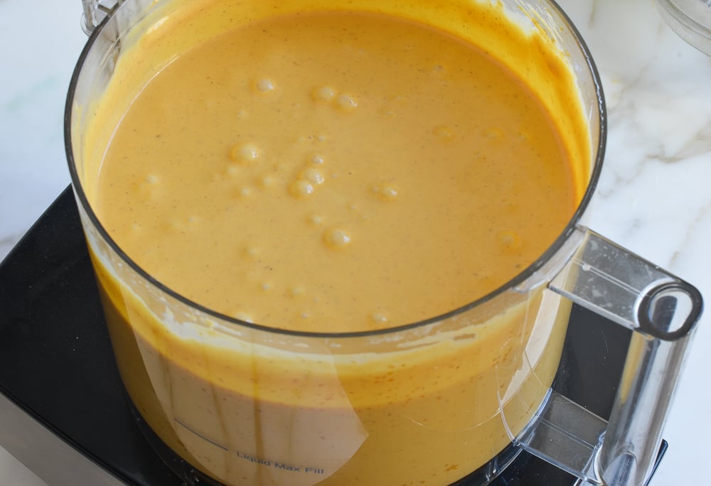 Light orange mixture in a food processor.