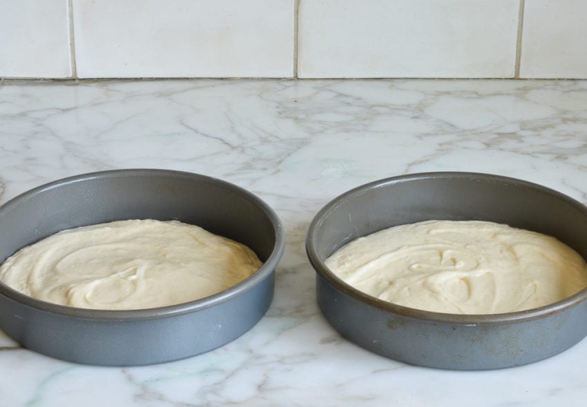 Round cake pans filled with batter.
