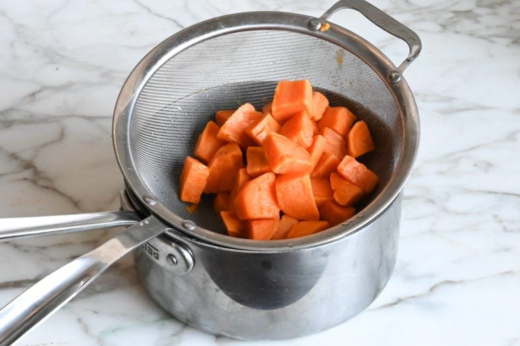 draining sweet potatoes