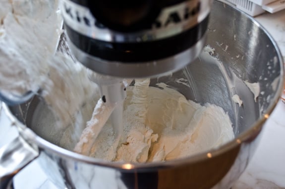 adding-dry-ingredients Dry ingredients pouring into a stand mixer of butter mixture.