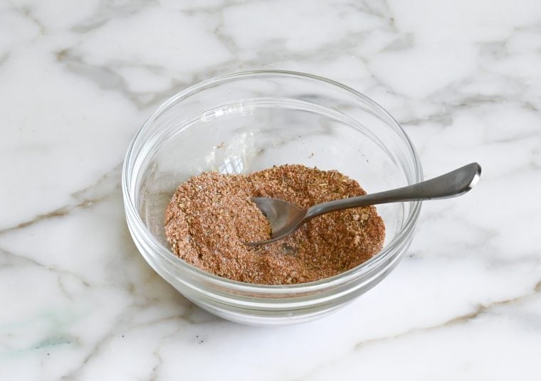 Spoon in a bowl of blackening rub.